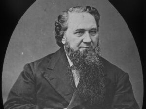 Portrait of a bearded man in 19th-century attire, showcasing a serious expression and historical significance.